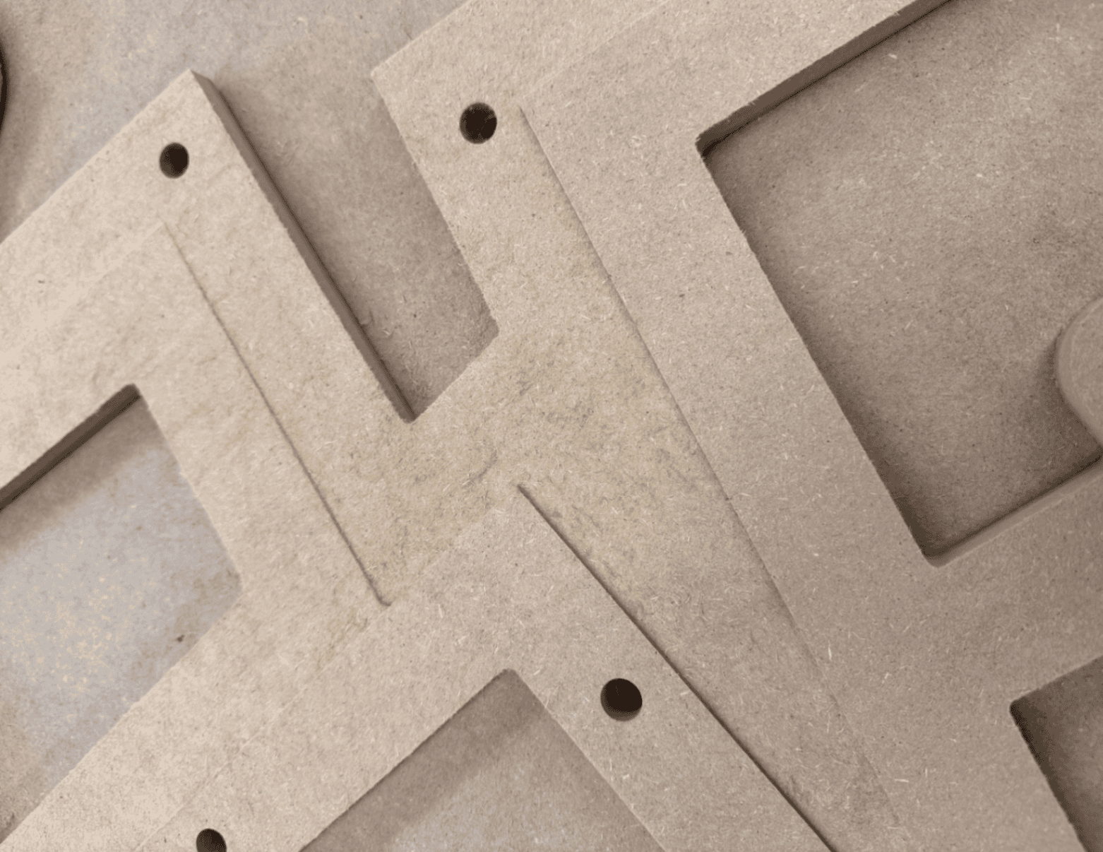 Close detail of the CNC-engraved black MDF surface shows archival newspaper text and imagery revealed in relief — Rosa Parks and Montgomery Bus Boycott headlines legible across the tilted figure face.