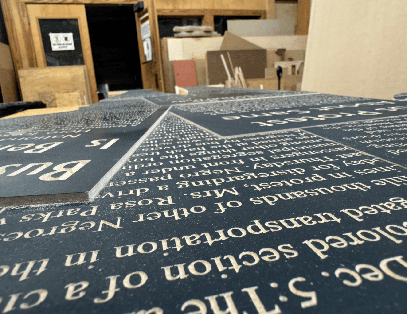 CNC-milled MDF structural subcomponents laid flat — interlocking bracket pieces with registration holes visible, cut to support the layered depth of the final figure assembly.